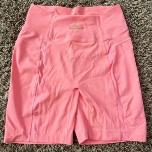 Gymshark X Whitney Simmons peach colored biker shorts, with mesh detail.